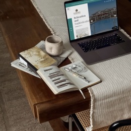 a laptop and books on a table