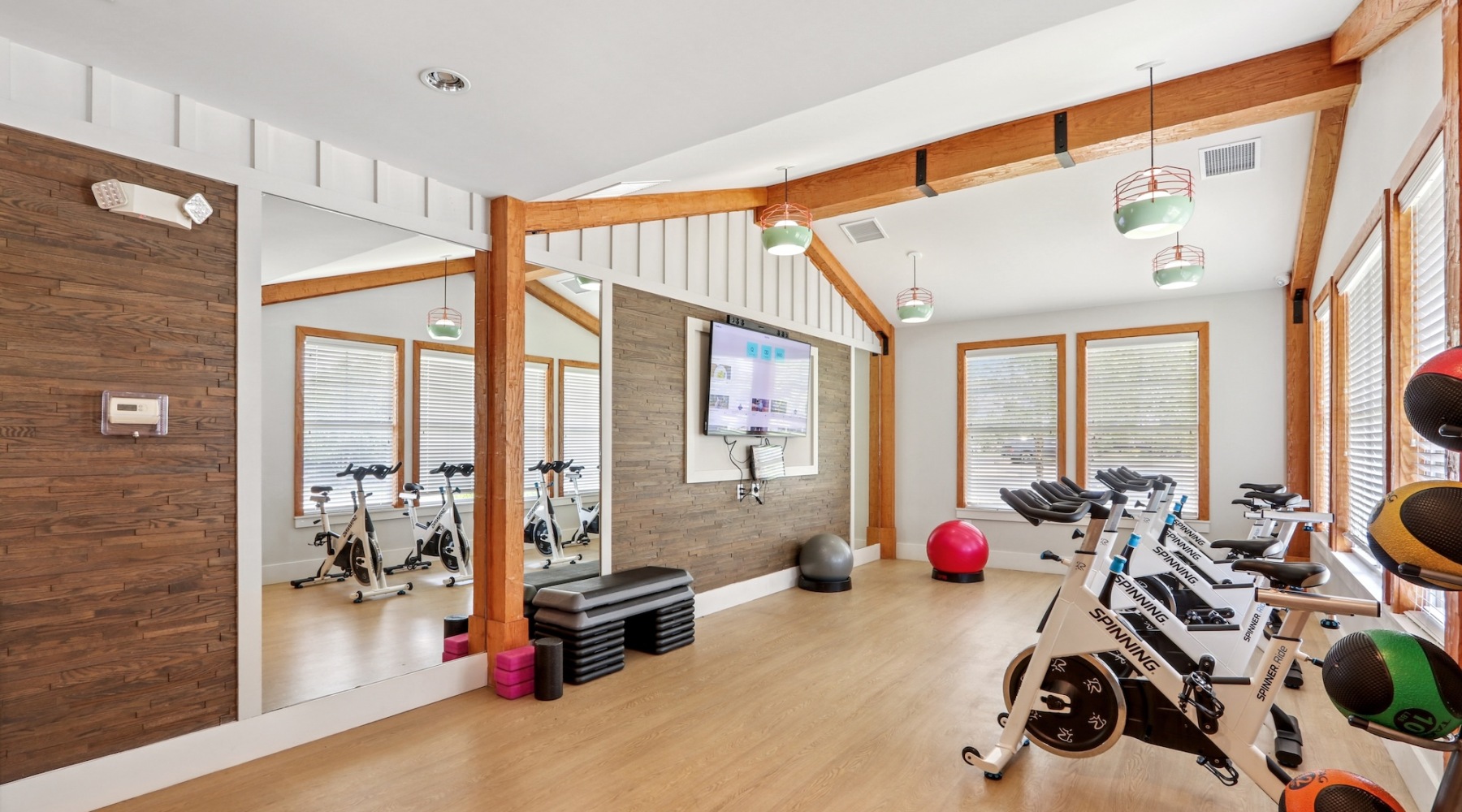 fitness center with rows of treadmills and modern style flooring
