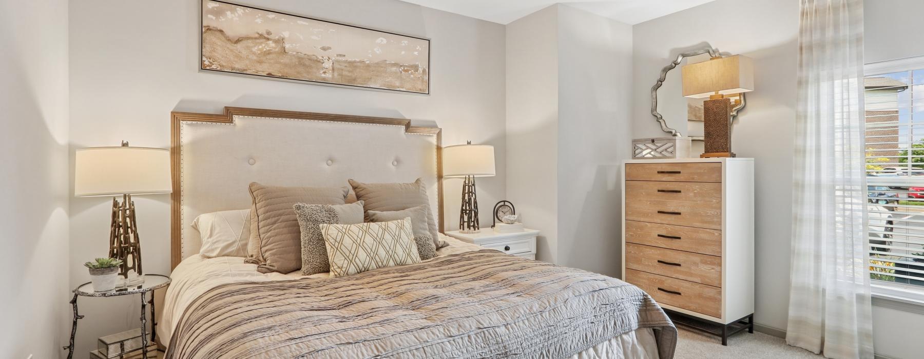 a bedroom with a bed and lamps