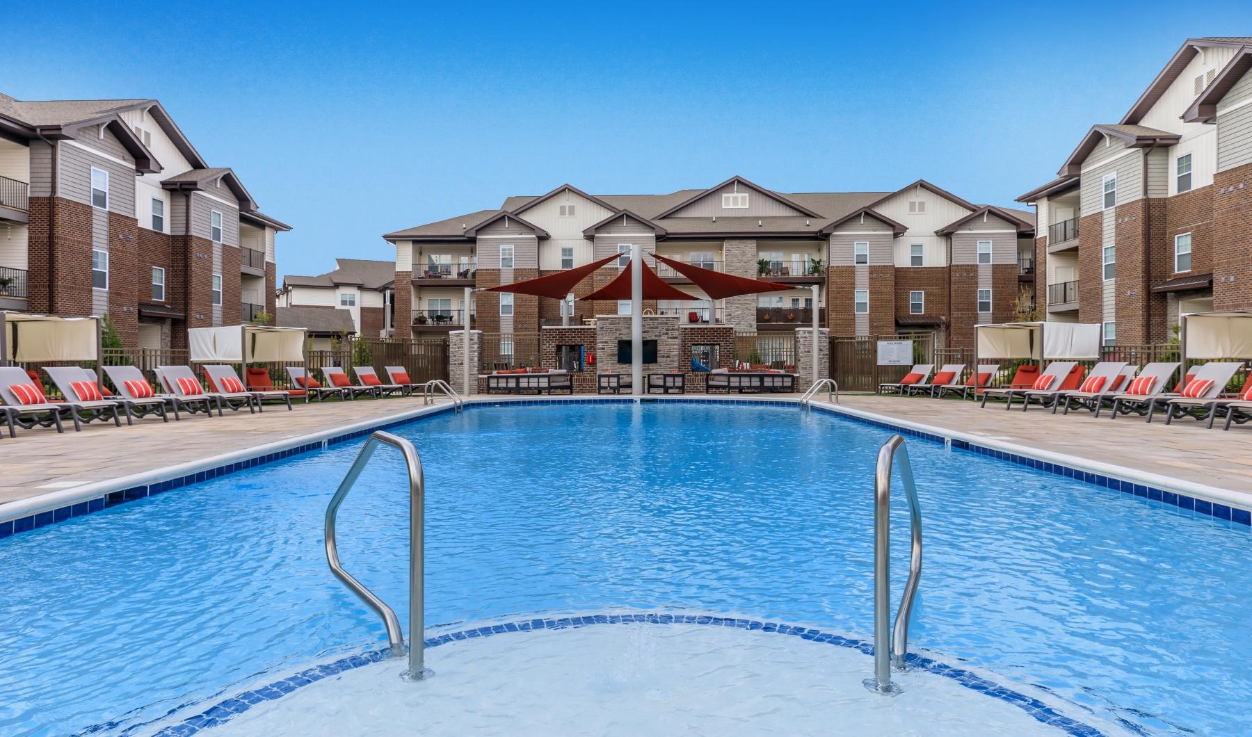 a swimming pool with a building in the background